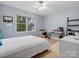 Well-lit bedroom with a large window and a ceiling fan with an adjacent desk and cabinetry at 2812 Edgebrook Cir, Matthews, NC 28105