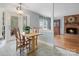 Cozy dining area with a view to the fireplace, wooden table set, and backyard at 2812 Edgebrook Cir, Matthews, NC 28105