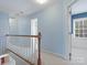 Bright and airy hallway with a view into a room with wainscoting and many windows at 2812 Edgebrook Cir, Matthews, NC 28105