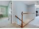 A carpeted hallway with wooden railings leading to a living area at 2812 Edgebrook Cir, Matthews, NC 28105