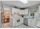 Bright kitchen featuring white cabinets, stainless steel appliances, and an open view to the adjacent dining room at 2812 Edgebrook Cir, Matthews, NC 28105