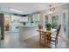 Bright kitchen featuring white cabinets, a breakfast bar, and access to a cozy screened-in porch at 2812 Edgebrook Cir, Matthews, NC 28105