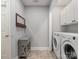 Well-lit laundry room featuring modern washer and dryer units and ample storage space at 2812 Edgebrook Cir, Matthews, NC 28105