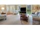 Bright living room with large windows, stylish furniture, and neutral carpet, creating a cozy atmosphere at 2812 Edgebrook Cir, Matthews, NC 28105