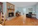 Inviting living room showcasing a fireplace, hardwood floors, and a comfortable armchair at 2812 Edgebrook Cir, Matthews, NC 28105