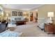 Comfortable living room with neutral carpet, stylish furniture, and an open view to the dining room, perfect for relaxation at 2812 Edgebrook Cir, Matthews, NC 28105