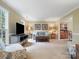 Cozy living room with a view to dining room, neutral carpet, and comfortable seating, ideal for Gathering gatherings at 2812 Edgebrook Cir, Matthews, NC 28105