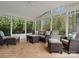 Inviting sunroom featuring comfortable wicker seating and serene outdoor view at 2812 Edgebrook Cir, Matthews, NC 28105