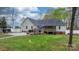 Home backyard featuring a garden, a deck, and a white fence at 2987 Irish St, Newton, NC 28658
