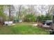 Expansive backyard with lush lawn, storage sheds, and a charming fire pit area at 2987 Irish St, Newton, NC 28658