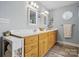 Bright bathroom featuring double sinks, wood vanity, and linen storage at 2987 Irish St, Newton, NC 28658