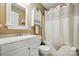 Bathroom showcasing a bathtub with shower, vanity, mirror, and storage cabinet at 2987 Irish St, Newton, NC 28658