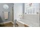 Bathroom with tub, shower, and decorative window at 2987 Irish St, Newton, NC 28658