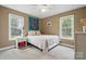 Cozy bedroom featuring neutral walls, two windows, ceiling fan, and comfortable carpeting at 2987 Irish St, Newton, NC 28658