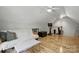 Bonus room with light hardwood floors, sofa, and workout equipment at 2987 Irish St, Newton, NC 28658