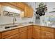 Charming kitchen featuring wooden cabinets, granite countertops, and stainless steel sink at 2987 Irish St, Newton, NC 28658