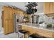 Kitchen with stainless steel fridge, granite counters, and pots hanging above island at 2987 Irish St, Newton, NC 28658