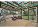 Covered porch featuring outdoor seating, hammock, ceiling fan, and translucent roof at 2987 Irish St, Newton, NC 28658