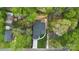 Aerial view of a home showcasing landscaping, lush greenery and a modern roof design at 3038 Northampton Dr, Charlotte, NC 28210