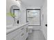 Bathroom featuring double sink vanity, round mirror, and glass enclosed shower-tub combo at 3038 Northampton Dr, Charlotte, NC 28210