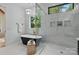 Bright bathroom featuring a soaking tub, walk-in glass shower, and modern vanity at 3038 Northampton Dr, Charlotte, NC 28210
