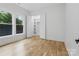 Bright bedroom boasts hardwood floors, natural light, and closet with built in shelving at 3038 Northampton Dr, Charlotte, NC 28210
