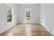Cozy bedroom featuring hardwood floors and natural light from multiple windows at 3038 Northampton Dr, Charlotte, NC 28210