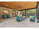 Covered outdoor living space with stained wood ceiling, brick wall, and plenty of seating at 3038 Northampton Dr, Charlotte, NC 28210