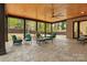 Spacious covered outdoor living space with stained wood ceiling, brick wall, and backyard view at 3038 Northampton Dr, Charlotte, NC 28210