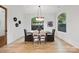 Bright dining room features wood floors, large windows, and modern chandelier lighting at 3038 Northampton Dr, Charlotte, NC 28210