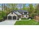 Charming two-story home with white brick, black accents, two-car garage, and manicured lawn at 3038 Northampton Dr, Charlotte, NC 28210