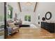 Bright main bedroom featuring vaulted ceiling, wood beam, and sitting area at 3038 Northampton Dr, Charlotte, NC 28210