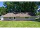 Home's backyard showcases a well-maintained green lawn at 307 S Ransom St, Gastonia, NC 28052