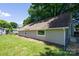 View of the house featuring a green lawn and beige siding at 307 S Ransom St, Gastonia, NC 28052