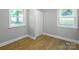 Bright bedroom with light gray walls, wood-look floors, and closet at 307 S Ransom St, Gastonia, NC 28052