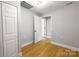Wood-look floors and trim detail this light gray bedroom at 307 S Ransom St, Gastonia, NC 28052