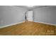 Expansive, wood-look flooring in this light gray bedroom at 307 S Ransom St, Gastonia, NC 28052