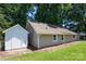 This home features vinyl siding, a shed, and a well-maintained green lawn at 307 S Ransom St, Gastonia, NC 28052