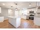 Bright kitchen with white cabinets, granite countertops, an island, and stainless steel appliances at 307 S Ransom St, Gastonia, NC 28052