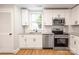 Updated kitchen with white cabinets, granite counters, and stainless steel appliances at 307 S Ransom St, Gastonia, NC 28052