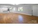 Large living space featuring wood laminate flooring with view of the kitchen at 307 S Ransom St, Gastonia, NC 28052