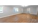 Spacious living space with wood laminate flooring and natural light from windows at 307 S Ransom St, Gastonia, NC 28052