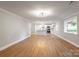 Open-concept living area featuring wood laminate flooring and open view to the kitchen at 307 S Ransom St, Gastonia, NC 28052