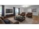 Comfortable living room with hardwood floors, modern furnishings, and a large window for natural light at 307 S Ransom St, Gastonia, NC 28052