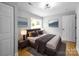 Cozy bedroom with a queen-sized bed, side tables, and stylish decor at 307 S Ransom St, Gastonia, NC 28052