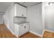 Pantry featuring white cabinets, granite countertops, and modern tile backsplash at 307 S Ransom St, Gastonia, NC 28052