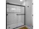 Modern walk-in shower boasts white subway tile and black trim at 307 S Ransom St, Gastonia, NC 28052