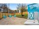 Backyard featuring a patio, lawn, a painted shed, and modern blue outdoor furniture at 318 Lake Montonia Rd, Kings Mountain, NC 28086
