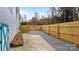 Spacious backyard featuring a gravel area, wood fence, and a shed with a blue painted door at 318 Lake Montonia Rd, Kings Mountain, NC 28086