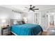 Cozy bedroom with a large bed, soft lighting, ceiling fan and a view of an ensuite bathroom at 318 Lake Montonia Rd, Kings Mountain, NC 28086